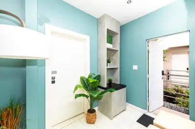 a blue hallway with a door and a plant at Sunny Days Apartments in Miami Beach