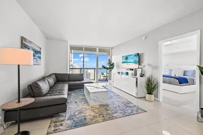 a living room with a couch and a bed at *ICONIC W ICON CONDO/ POOL&WATERVIEWS*FREESPA* in Miami