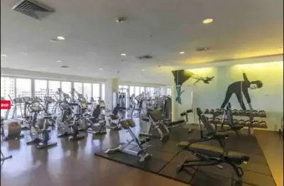a gym with a lot of exercise equipment and a monkey on the wall at *ICONIC W ICON CONDO/ POOL&WATERVIEWS*FREESPA* in Miami