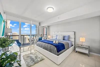 a bedroom with a bed and a balcony at *ICONIC W ICON CONDO/ POOL&WATERVIEWS*FREESPA* in Miami