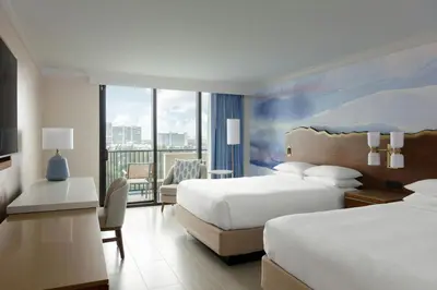 a hotel room with two beds and a balcony at Fort Lauderdale Marriott Harbor Beach Resort & Spa in Fort Lauderdale