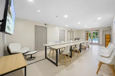 a conference room with a long table and chairs at Yacht Club Newly renovated parking included in Aventura