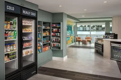 a grocery store aisle with food and drinks at Home2 Suites By Hilton Miami Airport South Blue Lagoon in Miami