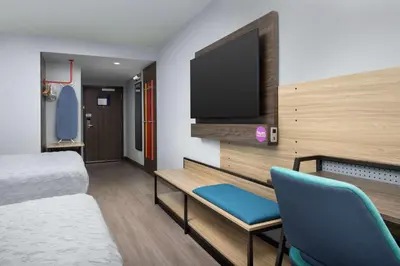 a room with a bed and a flat screen tv at Home2 Suites By Hilton Miami Airport South Blue Lagoon in Miami