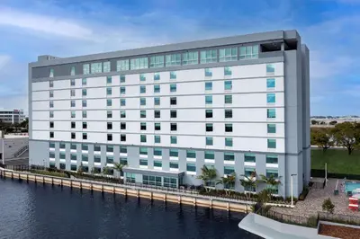 a rendering of a white building next to a body of water at Home2 Suites By Hilton Miami Airport South Blue Lagoon in Miami