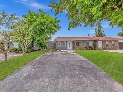 an empty driveway in front of a house at SuperVilla - Lakefront - Sunsets, Kayaks, Grill in Fort Lauderdale