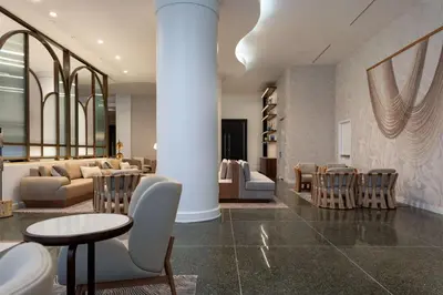 a lobby with chairs and a couch and a table at Hilton Cabana Miami Beach Resort in Miami Beach