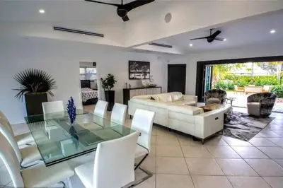 a living room with a couch and a glass table at SWAYING PALM BEACH HOUSE Walk to Beach , Marina, Port, las Olas in Fort Lauderdale