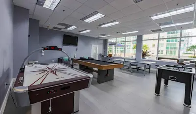 a large room with a ping pong table and pool tables at Two Bedroom Oceanview Apartment in Brickell in Miami