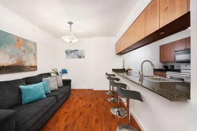 a living room with a couch and a kitchen at Two Bedroom Oceanview Apartment in Brickell in Miami
