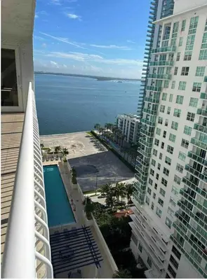 a view of the ocean from the balcony of a building at Two Bedroom Oceanview Apartment in Brickell in Miami