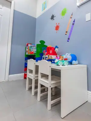 a dining room with a table with chairs and toys at Two Bedroom Oceanview Apartment in Brickell in Miami