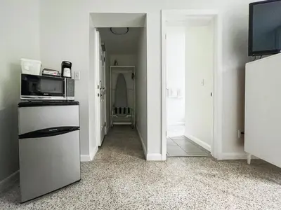 a kitchen with a refrigerator and a microwave at Tranquilo in Fort Lauderdale