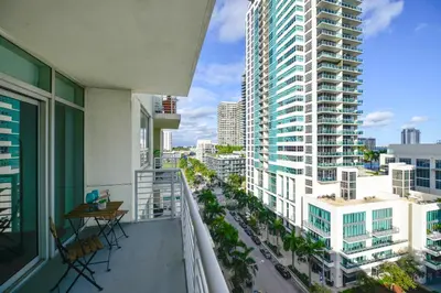 an apartment balcony with a view of a city at Relax Family Midtown - free parking & Great pool in Miami