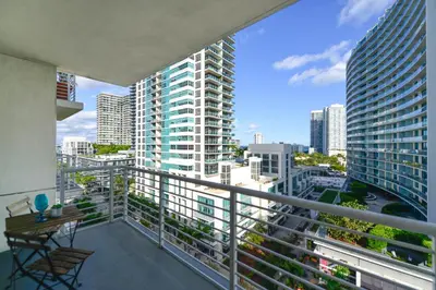 a balcony with a view of a city at Relax Family Midtown - free parking & Great pool in Miami