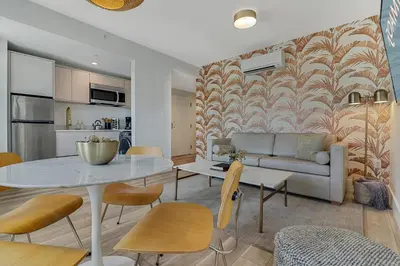 a living room with a table and a couch at Roami at The Carmela in Miami Beach