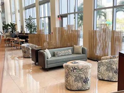 a lobby with a couch and chairs and tables at MVR Apartments at Marenas in Miami Beach