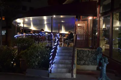a restaurant at night with lights on the stairs at Sea Club Ocean Resort in Fort Lauderdale
