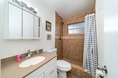 a bathroom with a sink and a toilet and a shower at Pool Home in Hollywood