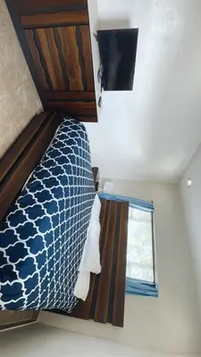 a bed in a small room with a window at Pool Home in Hollywood