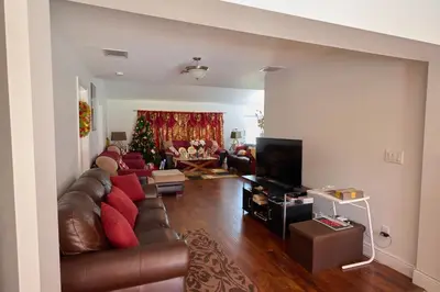 a living room with a leather couch and a television at Fabulous Hollywood Living Space in Hollywood