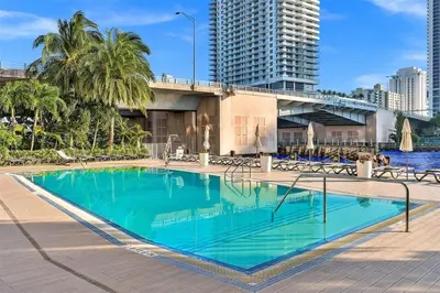 a swimming pool in the middle of a city at Beachwalk Resort Hallandale Ocean and Canal View Apartments 5 Min from the Beach in Hallandale Beach
