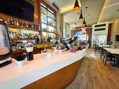 a restaurant with a counter with bowls of food at Beachwalk Resort Hallandale Ocean and Canal View Apartments 5 Min from the Beach in Hallandale Beach