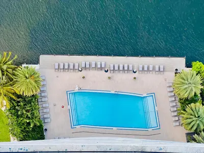 an overhead view of a swimming pool next to the water at Beachwalk Resort Hallandale Ocean and Canal View Apartments 5 Min from the Beach in Hallandale Beach