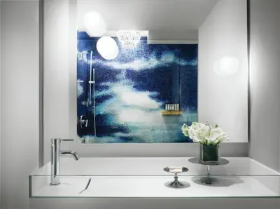 a bathroom with a sink with a vase of flowers at Mondrian South Beach in Miami Beach