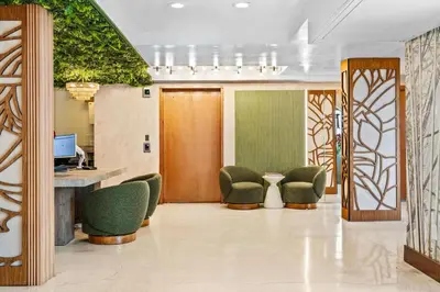 a lobby with green chairs and a desk in a building at Hotel Ocean in Miami Beach