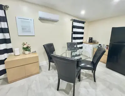 a dining room with a glass table and chairs at Cozy Private House near Miami Airport - Free parking - 01 in Miami