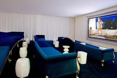 a waiting room with blue chairs and a flat screen tv at ICONIC LUXURIOUS HIGH CEILINGS UNIT BRICKELL w in Miami