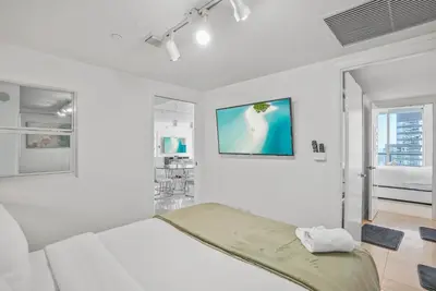a white bedroom with a bed and a window at Splendid Unit outstanding View-W Hotel Brickell in Miami
