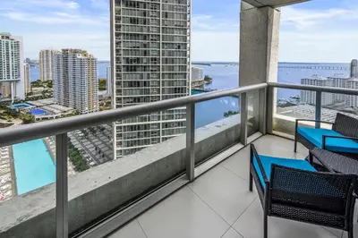 a balcony with chairs and a view of the ocean at Breathtaking Ocean View Unit Icon Brickell W in Miami