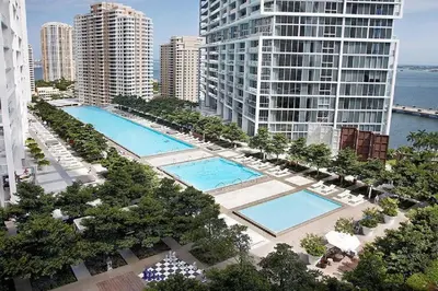 an aerial view of two pools in a city with buildings at Breathtaking Ocean View Unit Icon Brickell W in Miami