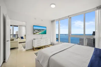 a bedroom with a bed and a view of the ocean at Breathtaking Ocean View Unit Icon Brickell W in Miami