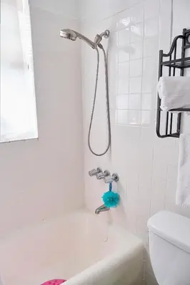 a white bathroom with a tub and a shower at Little Havana Executive 11 in Miami