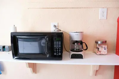 a microwave sitting on a shelf next to a coffee maker at Little Havana Executive 11 in Miami