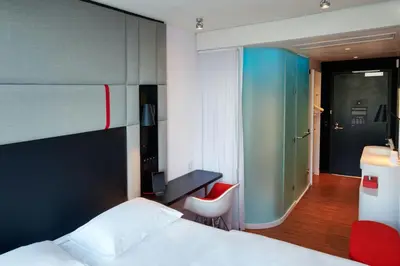 a bedroom with a bed and a desk and a chair at citizenM Miami World Center in Miami
