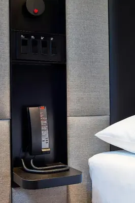 a hotel room with a phone in a hotel room at citizenM Miami World Center in Miami