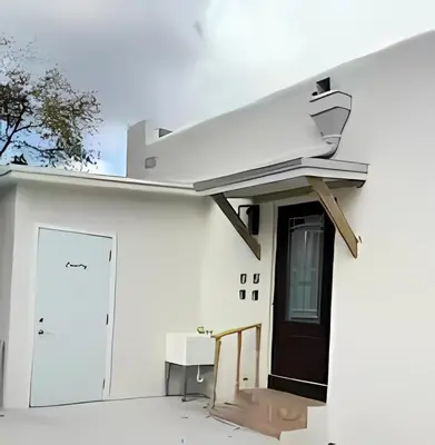 a white house with a black door and a door istg istg at Pretty Private Room, near the Airport - Free parking - 01 in Miami