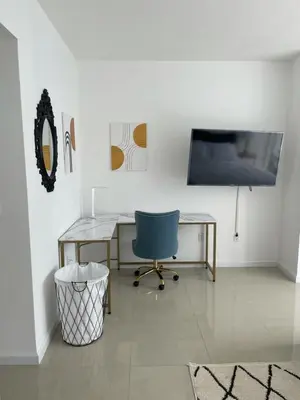 a room with a desk and a tv and a chair at IconBrickell Tower 3 W Residences in Miami