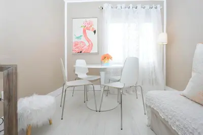 a white dining room with a table and chairs at South of Fifth Ocean Drive Apt in Miami Beach