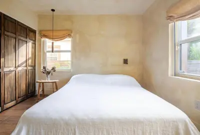 a bedroom with a large white bed and two windows at Casa Ishi - at lumicollection in Miami