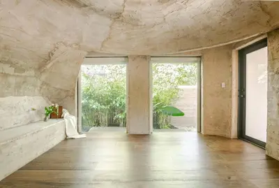 a room with a stone wall and a large window at Casa Ishi - at lumicollection in Miami