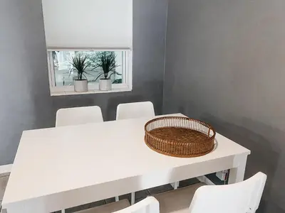 a white table with white chairs and a basket on it at Lovely Bohemian Apartment in Fort Lauderdale