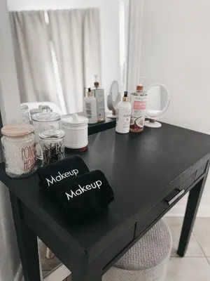 a black table with makeup items on it at Lovely Bohemian Apartment in Fort Lauderdale