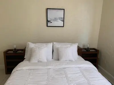 a bed with white pillows and a picture on the wall at Cozy Private Room, near the Airport - Free parking - 01 in Miami