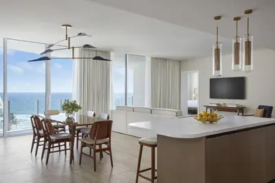a kitchen and dining room with a view of the ocean at Four Seasons Hotel and Residences Fort Lauderdale in Fort Lauderdale