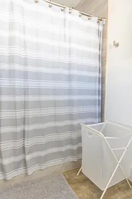 a bathroom with a shower curtain and a tub at MIAMI PARADISE in Miami
